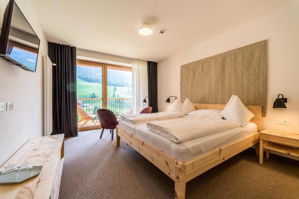Postel nebo postele na pokoji v ubytování Hotel Tyrol