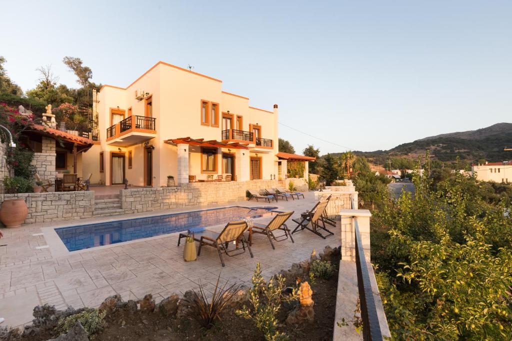 a villa with a swimming pool and a house at Ageri Traditional Villa in Argyroupolis