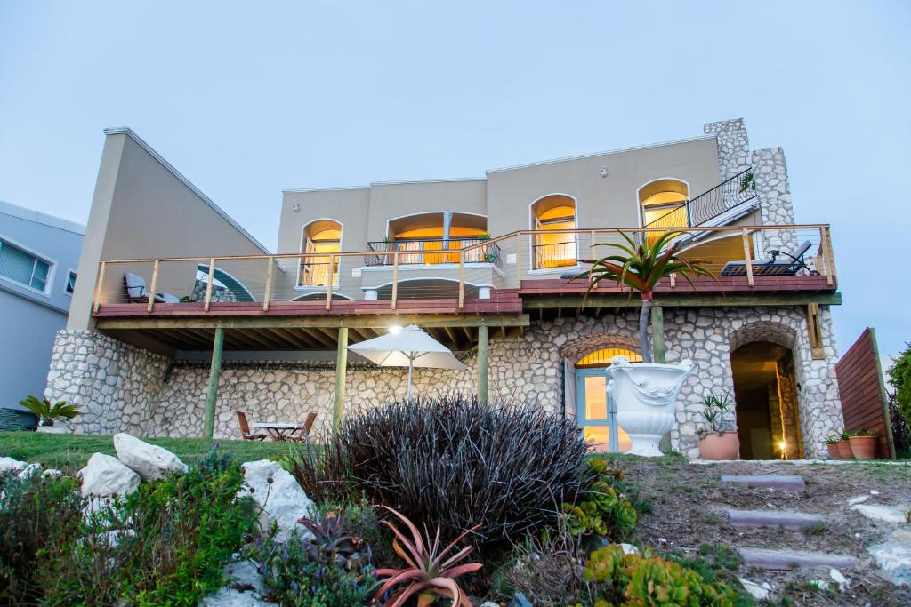 a house with a balcony on top of it at Villa Pescatori in Yzerfontein