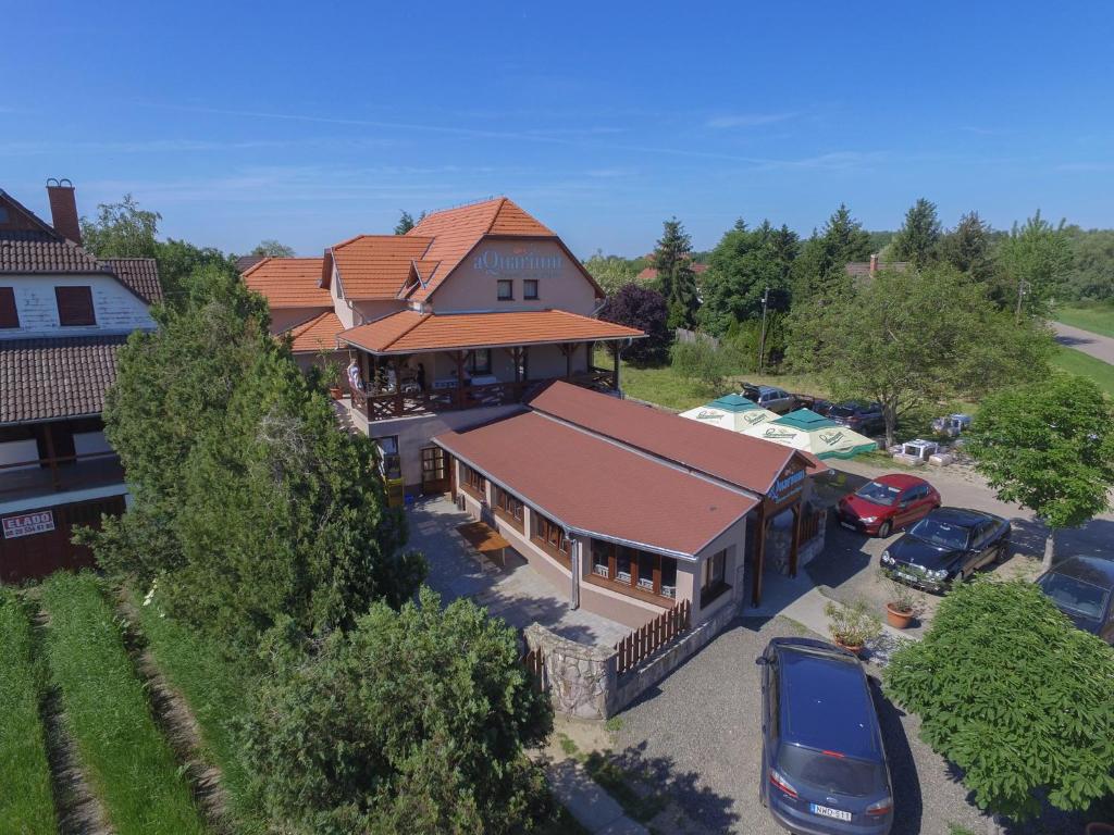 an aerial view of a house with cars parked in a parking lot at aQuarium Panzió in Abádszalók