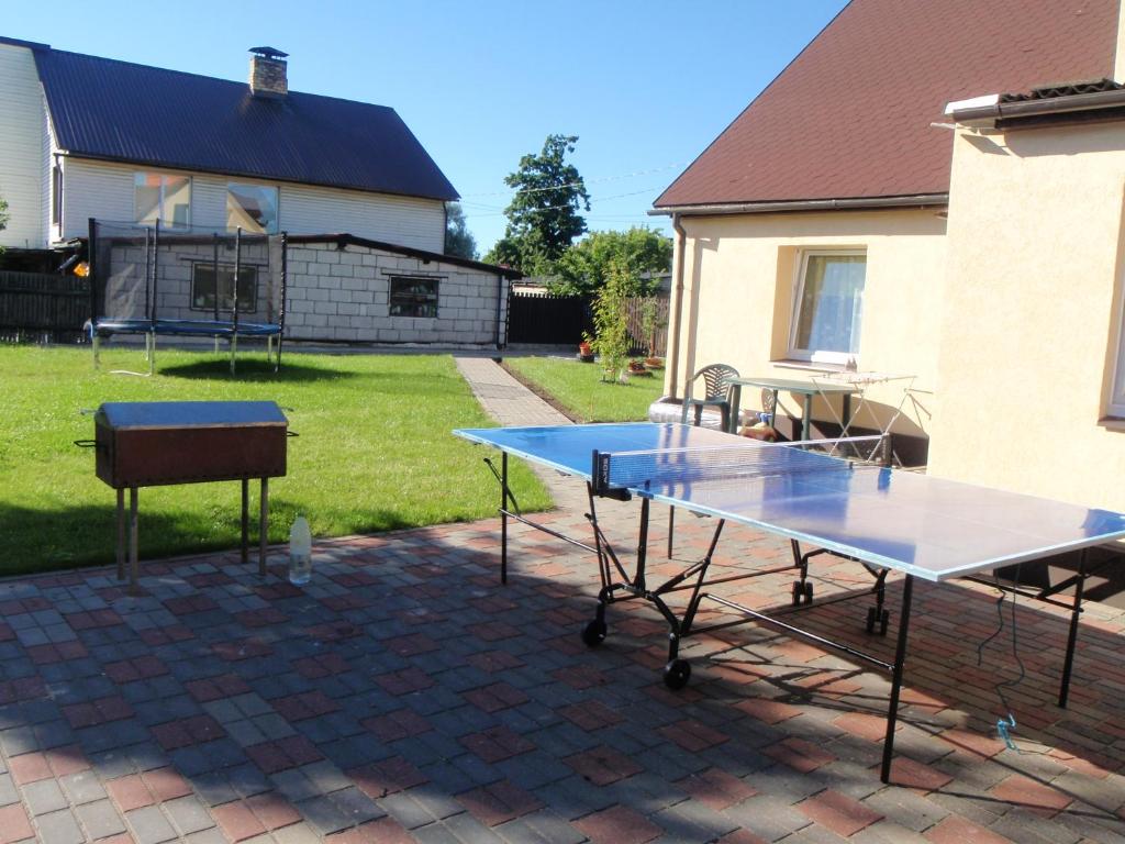 two ping pong tables on a brick patio at Ozola street apartment in Ventspils