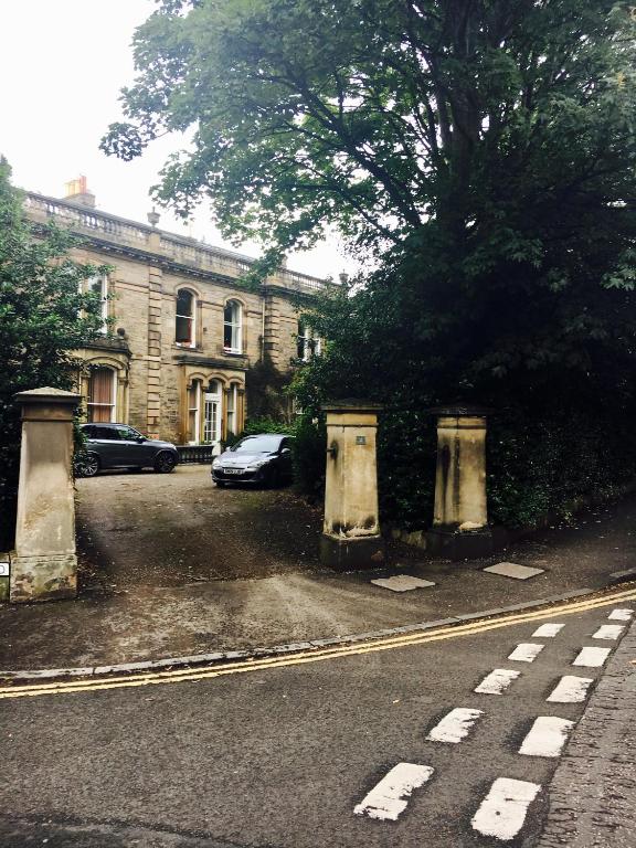 a street with a building and cars parked in front at Georgian House Boutique B&B in Edinburgh