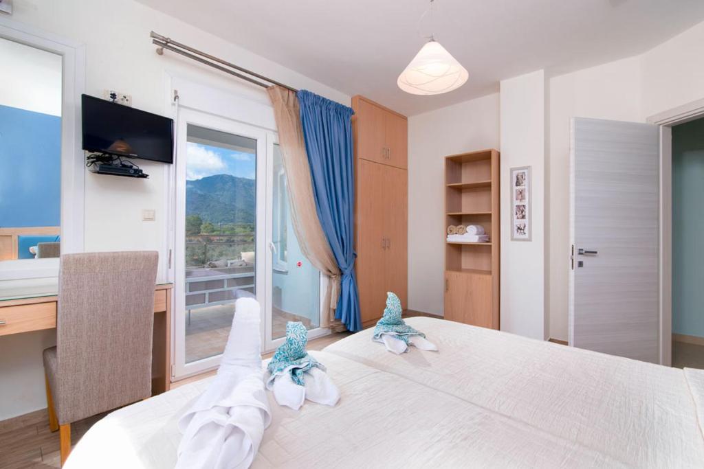 Posteľ alebo postele v izbe v ubytovaní Olive Garden Villas and Apartments