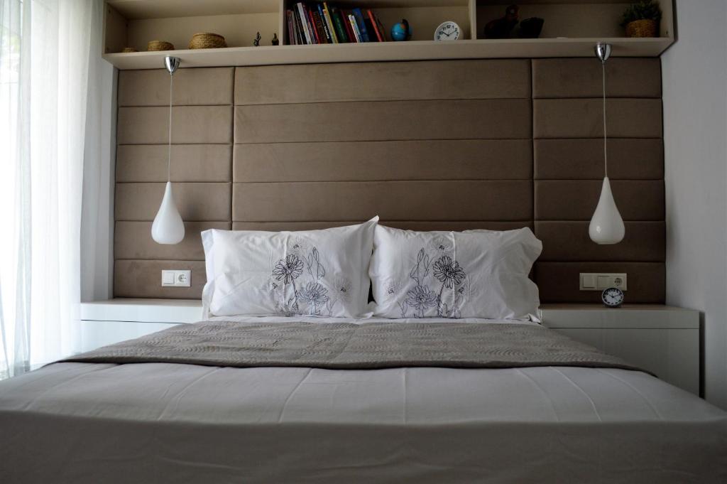 a bedroom with a large bed with white pillows at Athens Nest in Athens