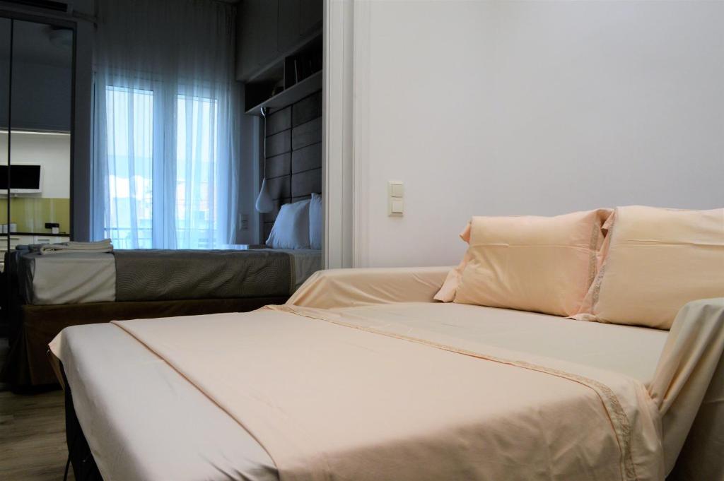 Postel nebo postele na pokoji v ubytování Athens Nest