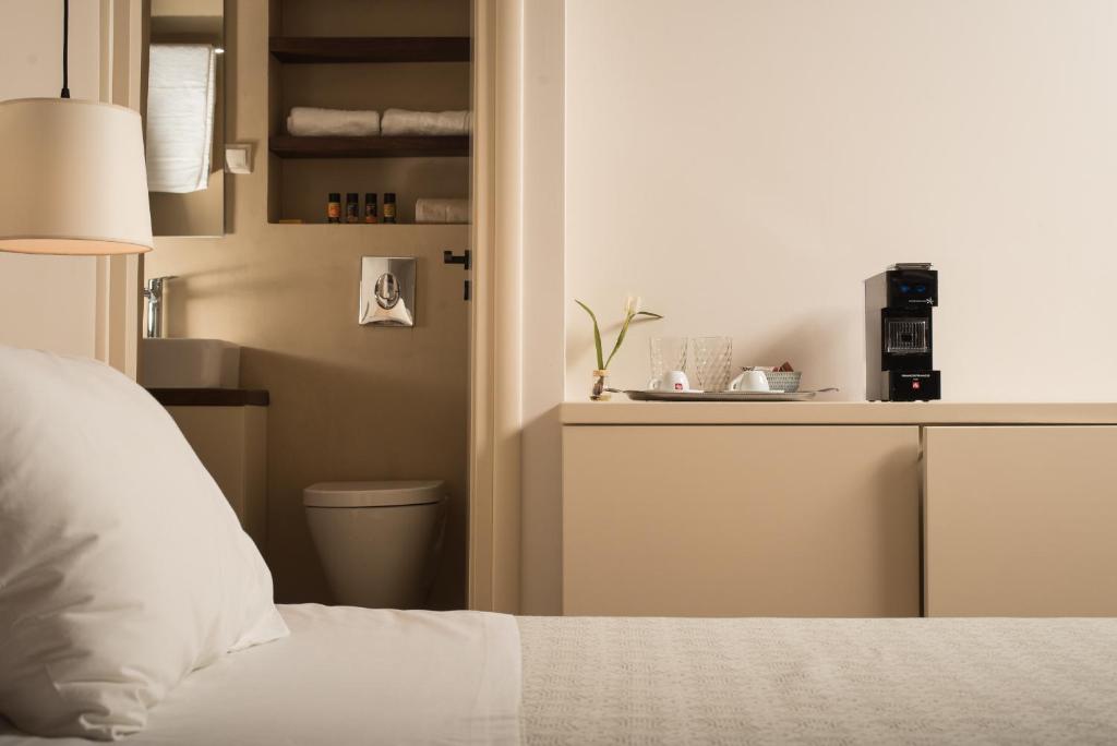 Un ou plusieurs lits dans un hébergement de l'établissement Nonnalena Boutique Hotel