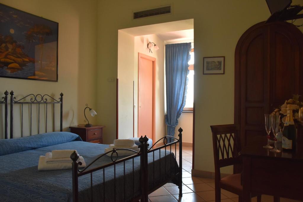 a bedroom with a bed and a window and a door at Hotel Risorgimento in Agerola