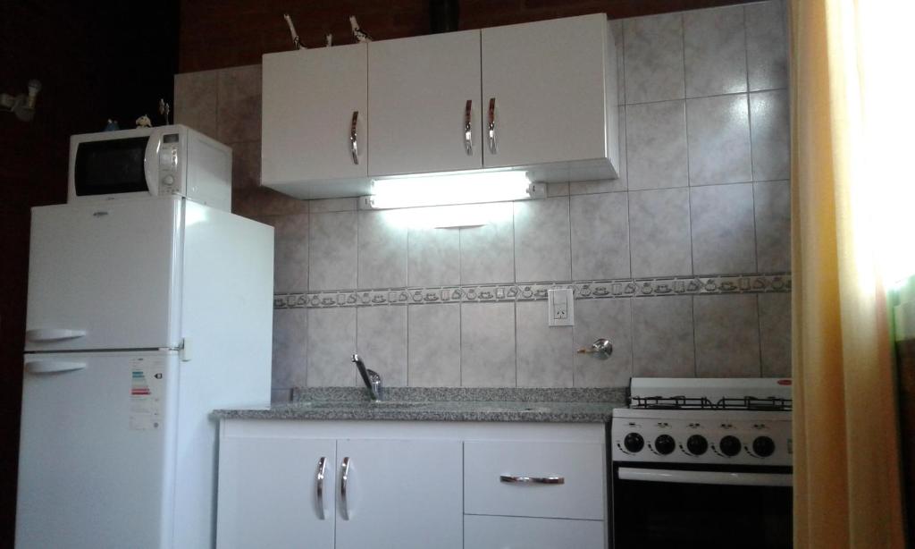 Kuchyň nebo kuchyňský kout v ubytování Cabañas Llajta Sumaj