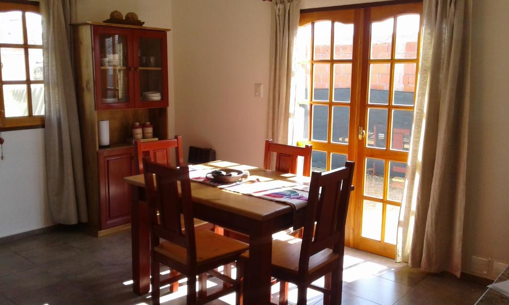 uma sala de jantar com uma mesa e cadeiras e uma janela em Isabel em Alta Gracia