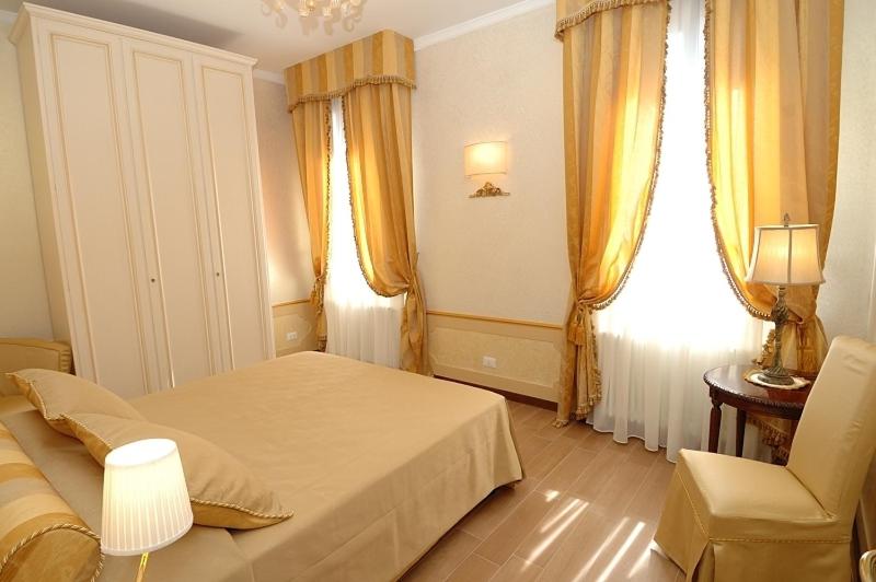 A bed or beds in a room at Corte dei Santi