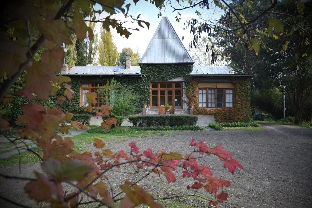 a brick house with a large window in front of it at La Casona del Rio in Trelew