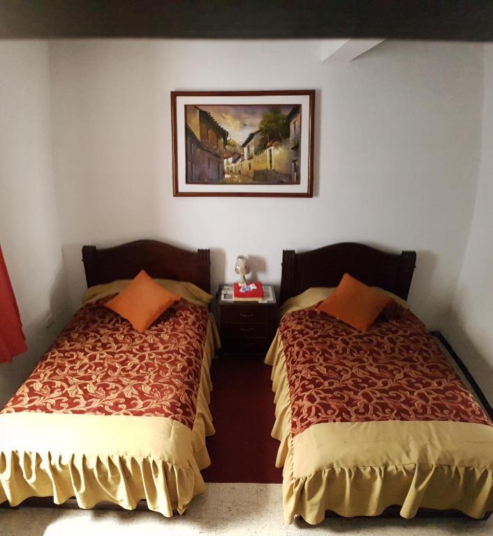 Postel nebo postele na pokoji v ubytování Hostal Flores