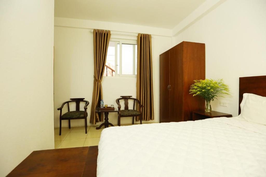 Postel nebo postele na pokoji v ubytování Viet Huong Hotel
