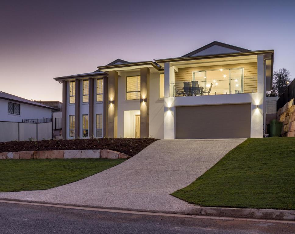 a large house with a driveway in front of it at Brand New Executive Living 36 in Bundamba