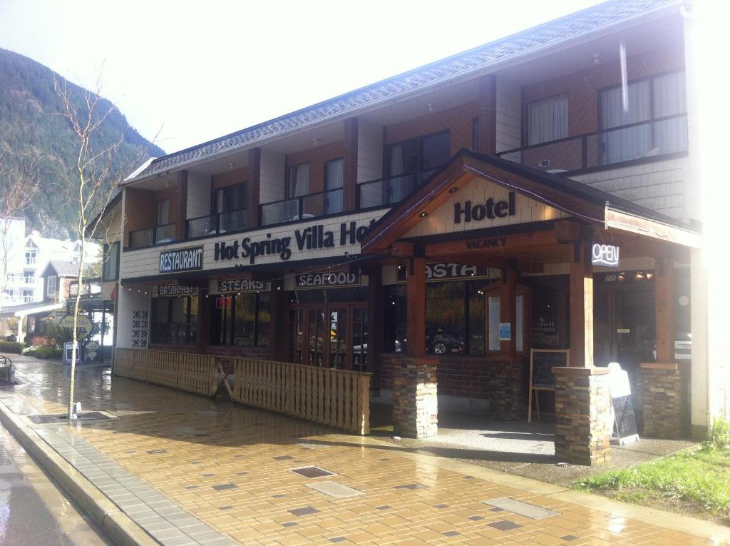 un edificio con un hotel en una calle lluviosa en Spring Villa Hotel en Harrison Hot Springs