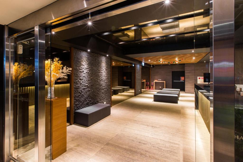 a lobby of a building with a couch and tables at Chance Hotel in Taichung