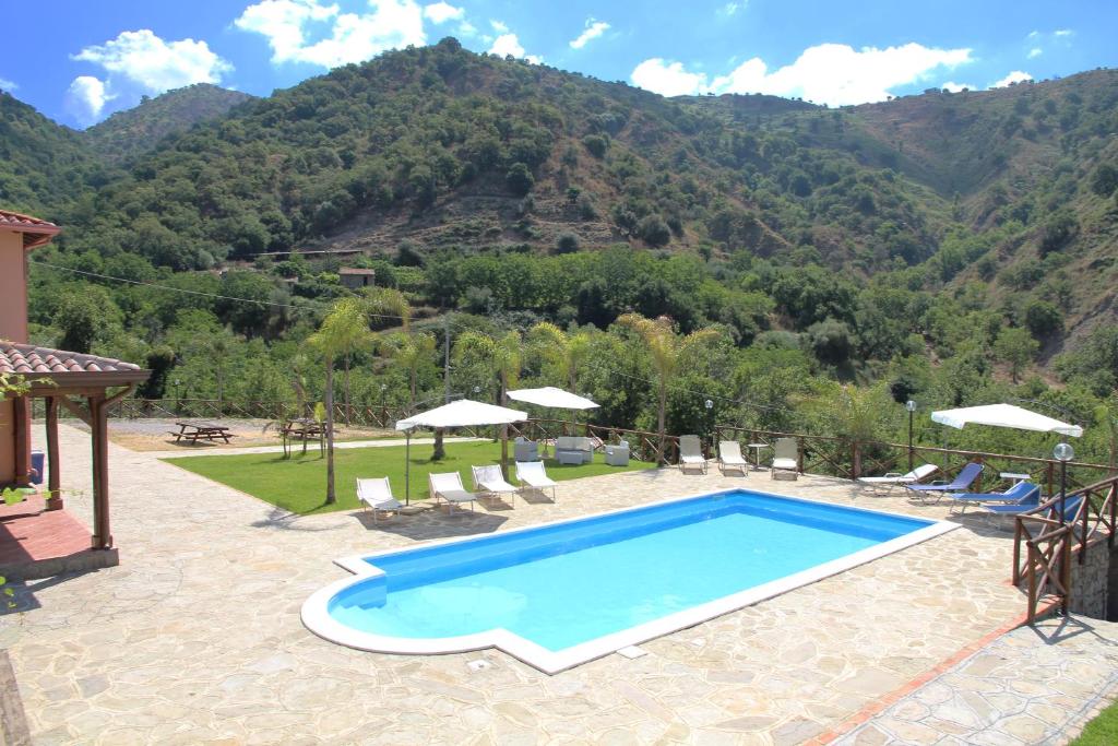 a swimming pool with a view of a mountain at Profetina Village in Motta Camastra