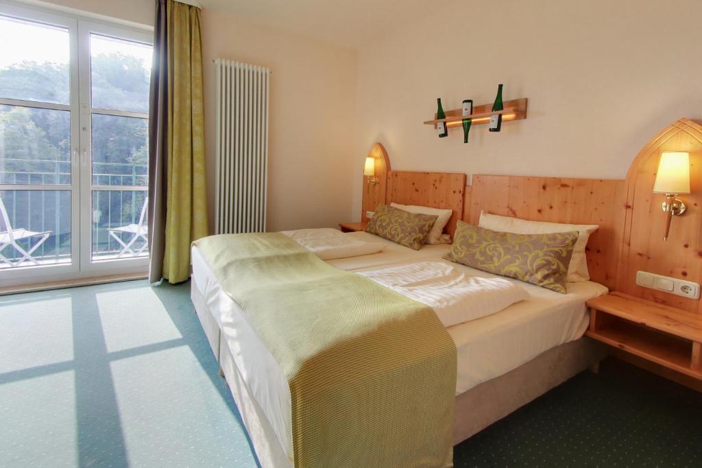 Postel nebo postele na pokoji v ubytování Akzent Waldhotel Rheingau