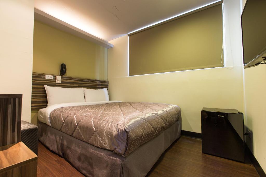 a bedroom with a bed in a room at Chance Hotel in Taichung