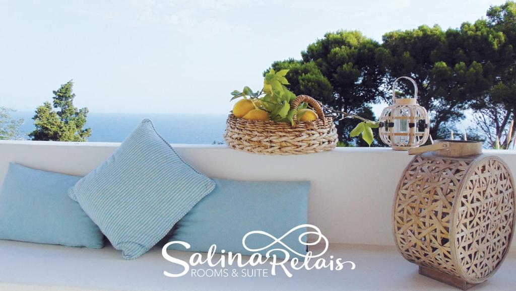 a pillow and a basket of fruit on a ledge at SalinaRelais Rooms&Suite in Malfa