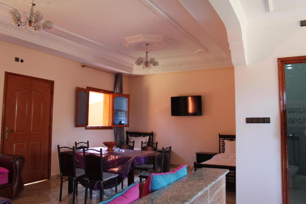 a dining room with a table and chairs at Hôtel Ajil Cascades D'ouzoud in Ouzoud