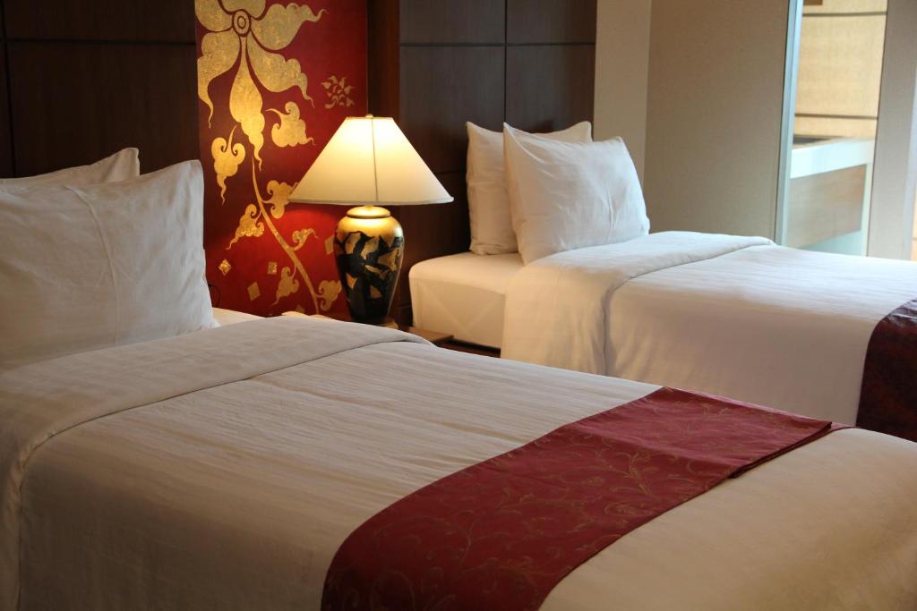Postel nebo postele na pokoji v ubytování Mariya Boutique Hotel At Suvarnabhumi Airport