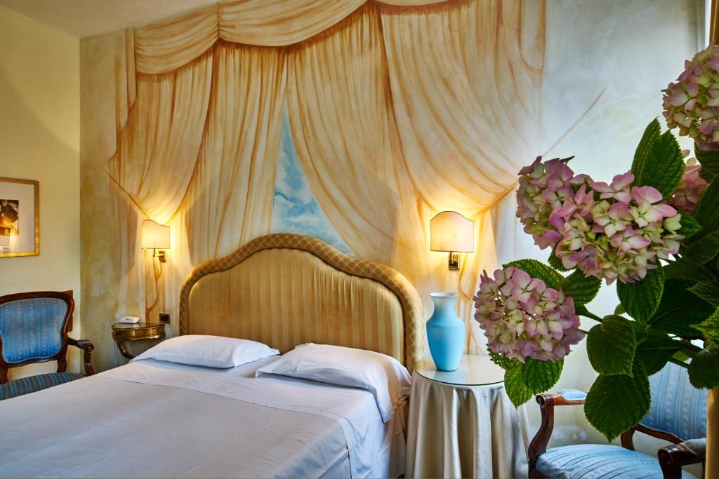 a bedroom with a bed with a canopy at Hotel Gardena in Venice