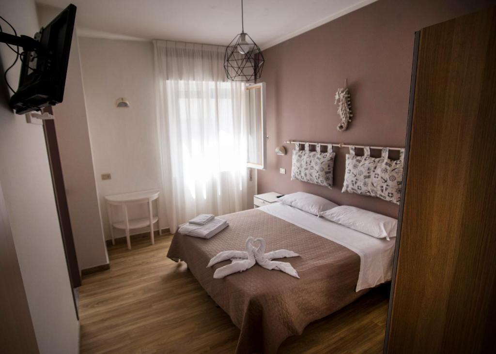 Postel nebo postele na pokoji v ubytování Hotel 21 Riccione