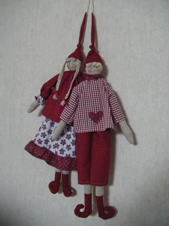 deux poupées dans des robes suspendues sur un mur dans l'établissement Les Lutins, à Sainte-Ruffine