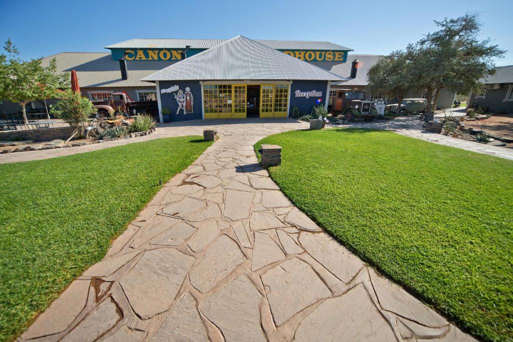 een loopbrug voor een winkel met een gebouw bij Gondwana Canyon Roadhouse in Stamprivier