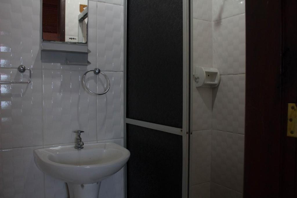 a small bathroom with a sink and a shower at Pousada Betel - Moradas Familia Betel in Salvador