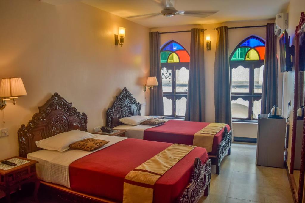 Postel nebo postele na pokoji v ubytování Tembo Palace Hotel
