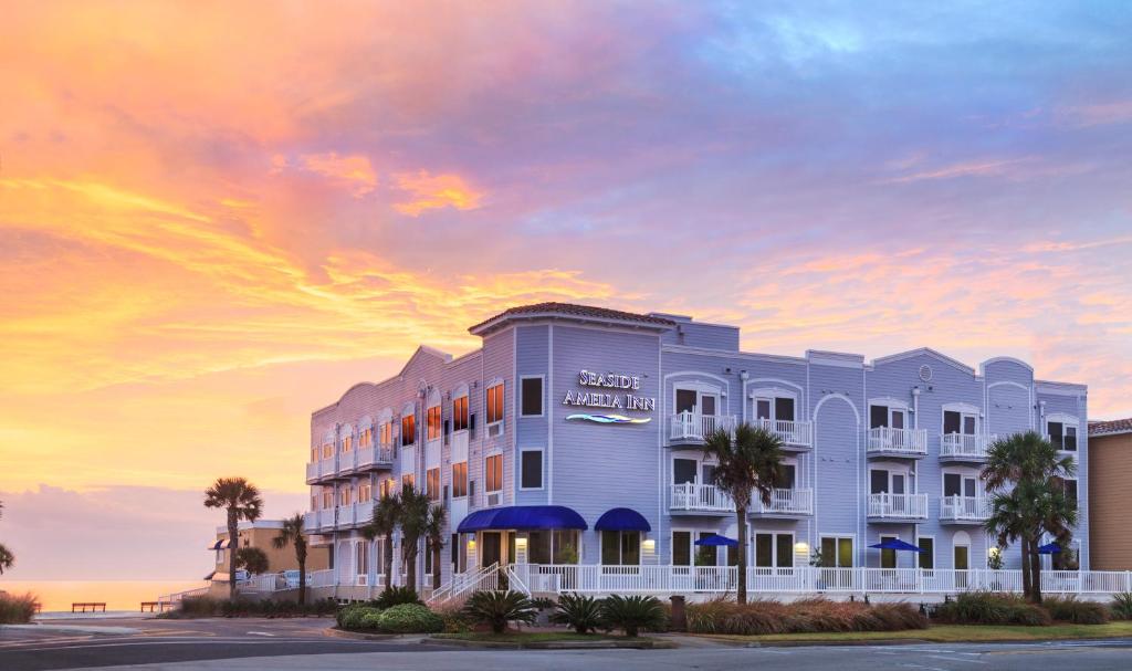a rendering of a hotel with a sunset in the background at Seaside Amelia Inn - Amelia Island in Amelia Island