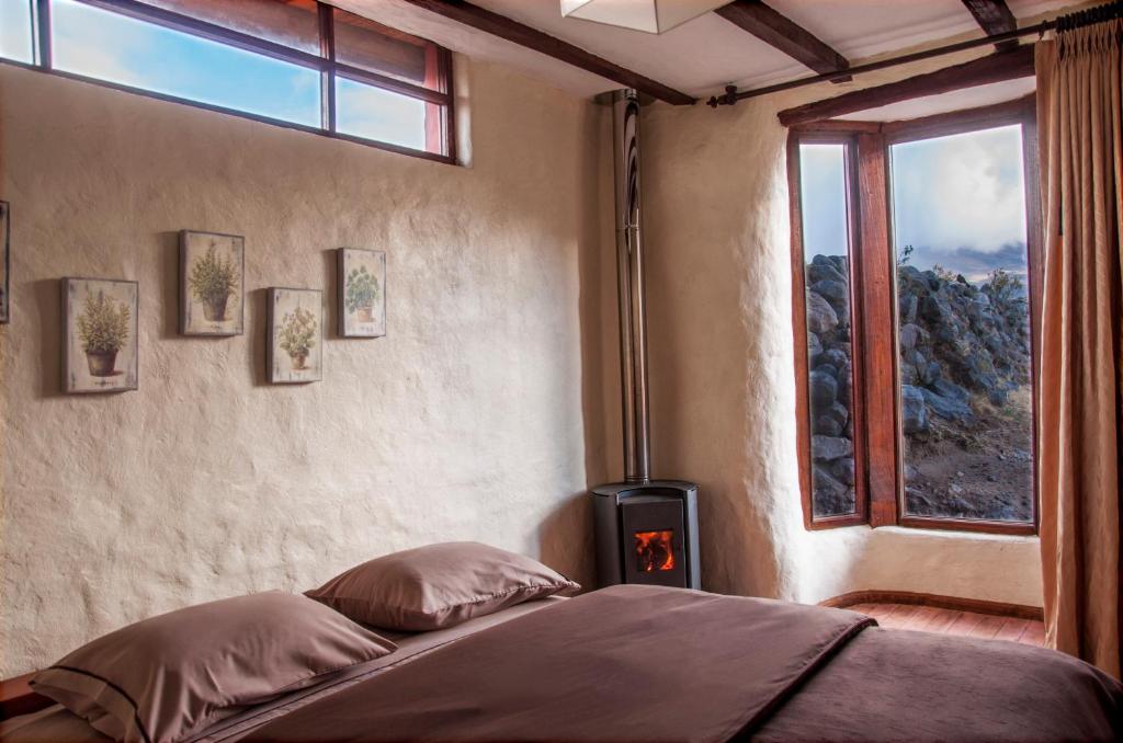 Postel nebo postele na pokoji v ubytování Hotel Tambopaxi