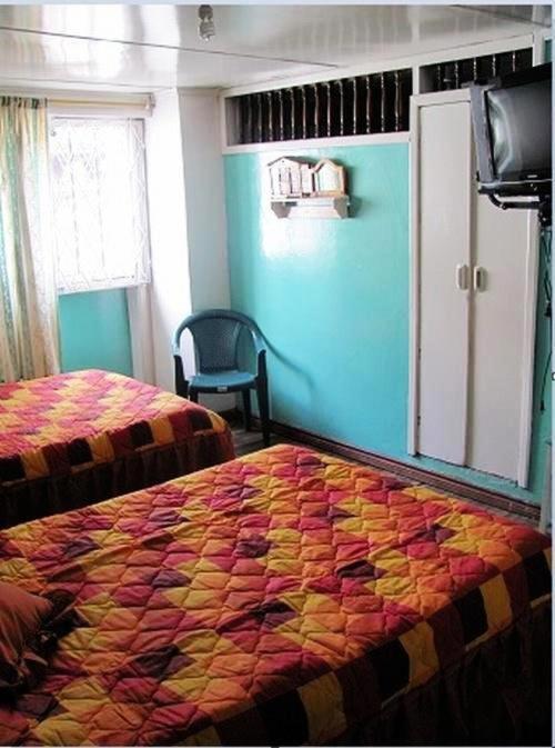 Postel nebo postele na pokoji v ubytování Hostal Yumbo Imperial
