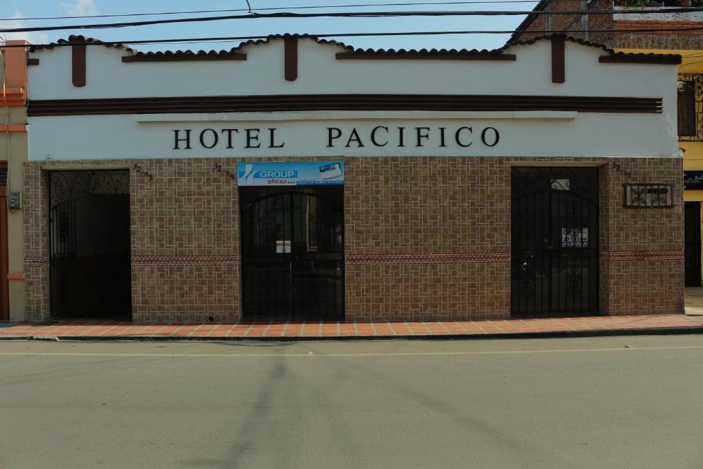 a hotel patricolis building on the corner of a street at Hotel Pacifico in Palmira