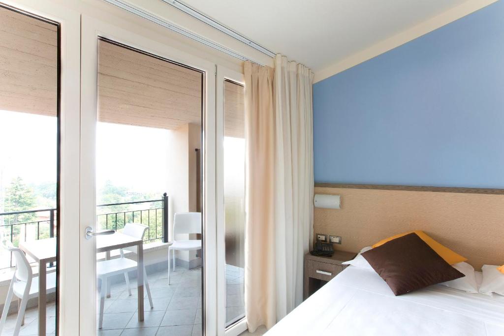 Postel nebo postele na pokoji v ubytování Hotel Belvedere