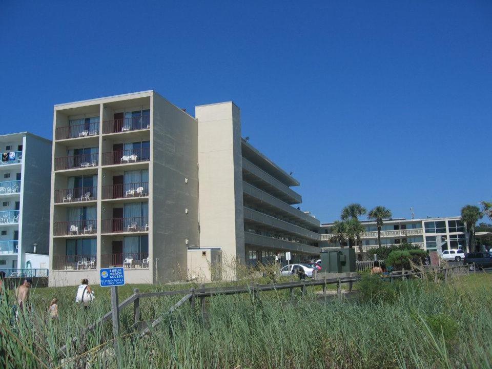 an apartment building with a sign in front of it at Oceanfront Viking Motel in Myrtle Beach