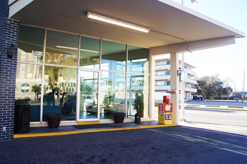 a store front with glass windows on a street at Oceanfront Viking Motel in Myrtle Beach