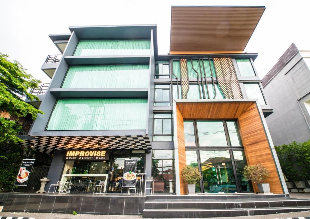 a facade of a building with a store at Jira Boutique Residence in Chiang Mai