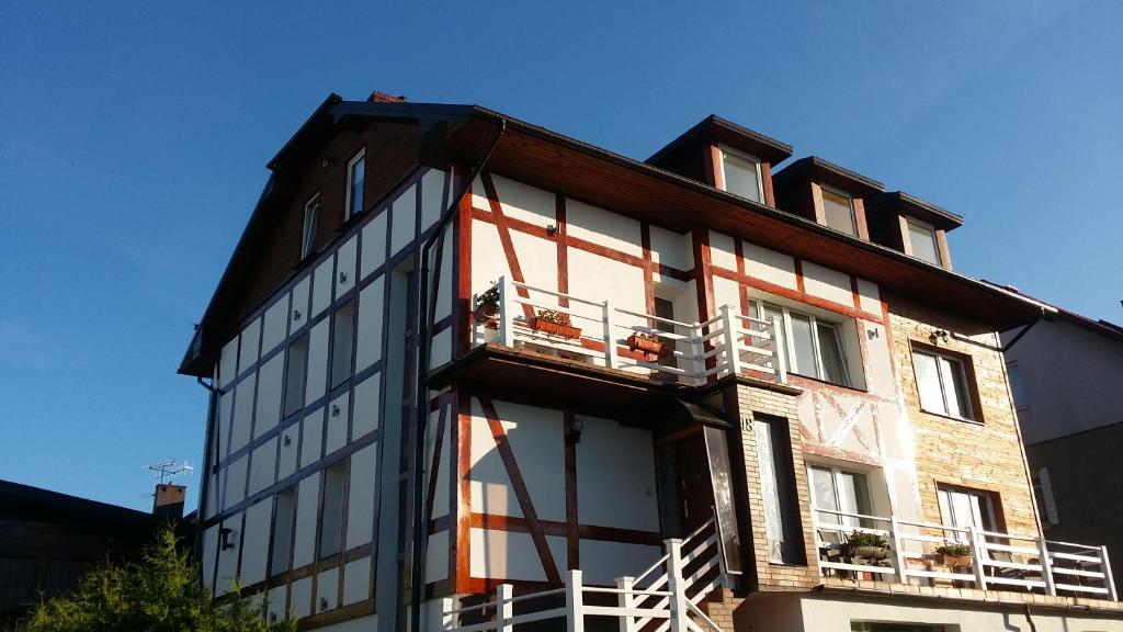 a building with two balconies on the side of it at Oceania Mielno in Mielno