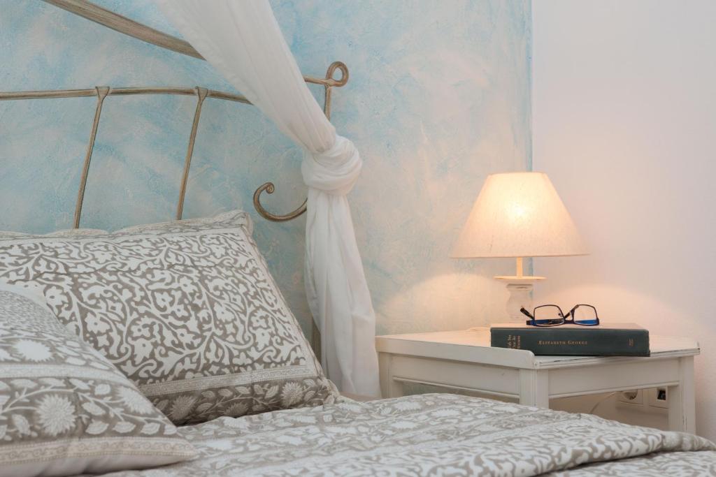 a bedroom with a bed and a table with a lamp at 9 Muses Naxos Beach hotel in Kastraki