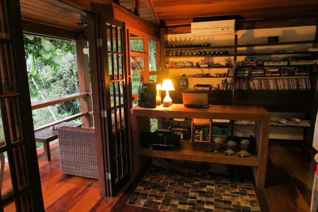 a room with a table with a lamp on it at Atlantica Jungle Lodge in Abraão