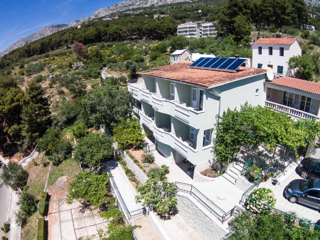 an aerial view of a house with solar panels on its roof at Guesthouse Dominović in Brela