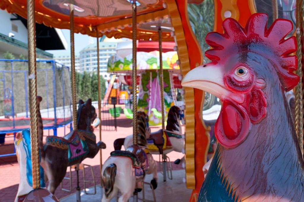 a carousel with a chicken on a carousel at Delphin Imperial Lara in Lara