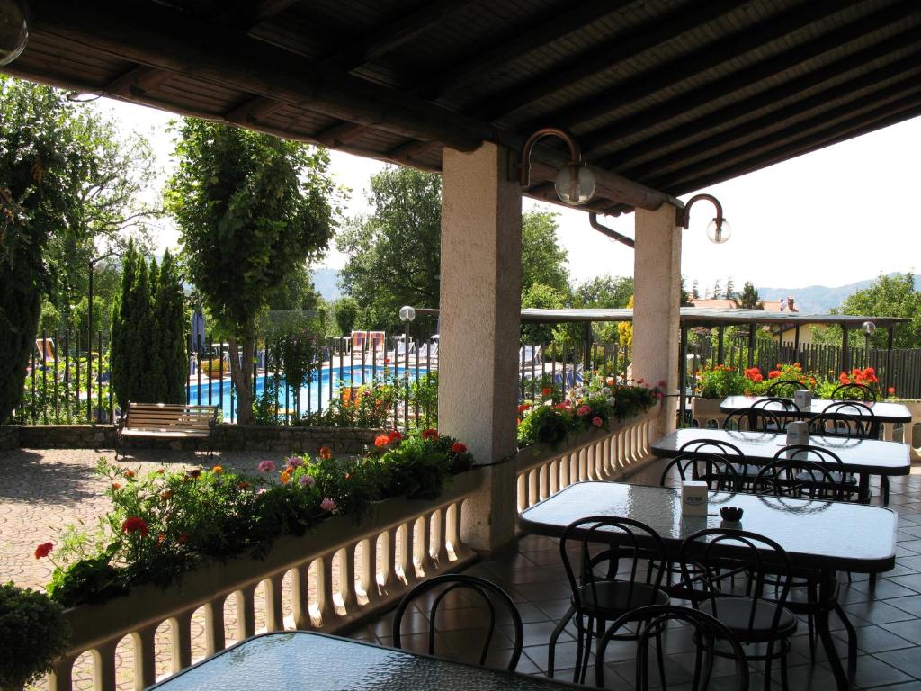 a patio with tables and chairs and a pool at Stevano Albergo e Ristorante in Cantalupo Ligure