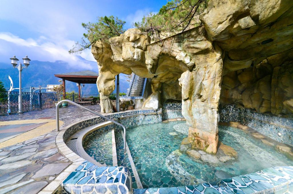 a large swimming pool in a rock wall at Dongpo Ti Lun Hotel in Xinyi