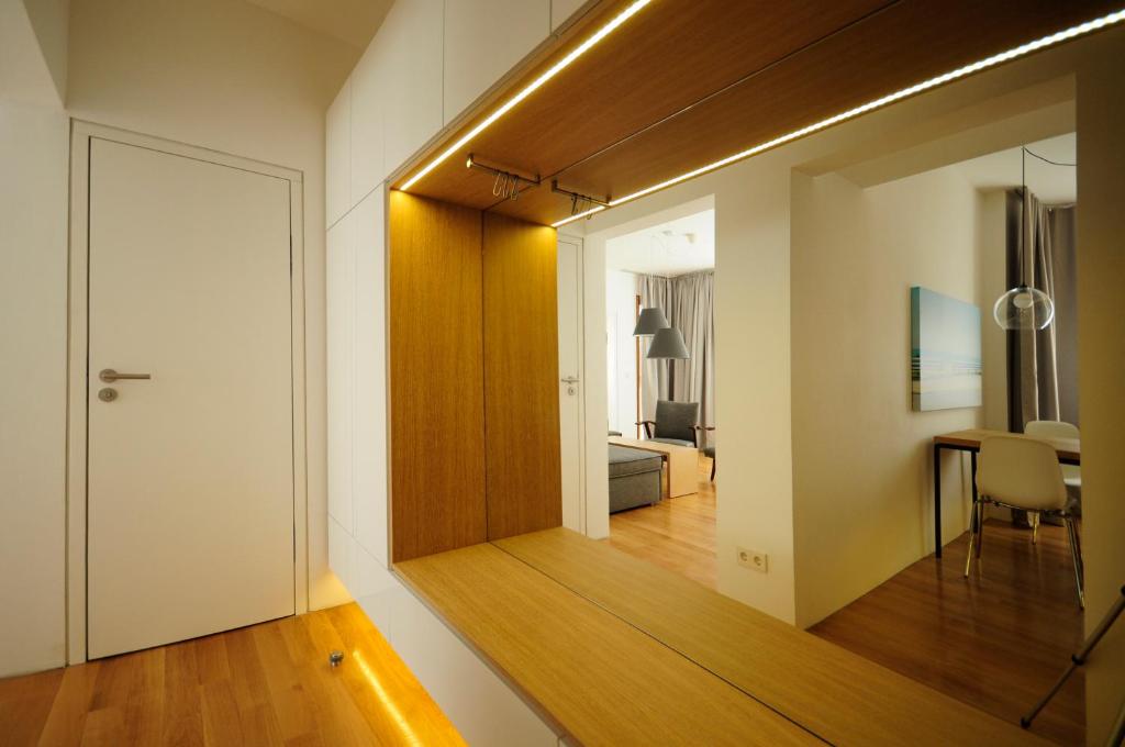 a hallway with a mirror and a room with a bedroom at Design Apartment in Park in Sofia