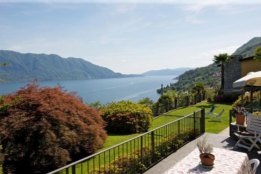 a house with a balcony with a view of the water at Casa Balon in Oggebbio