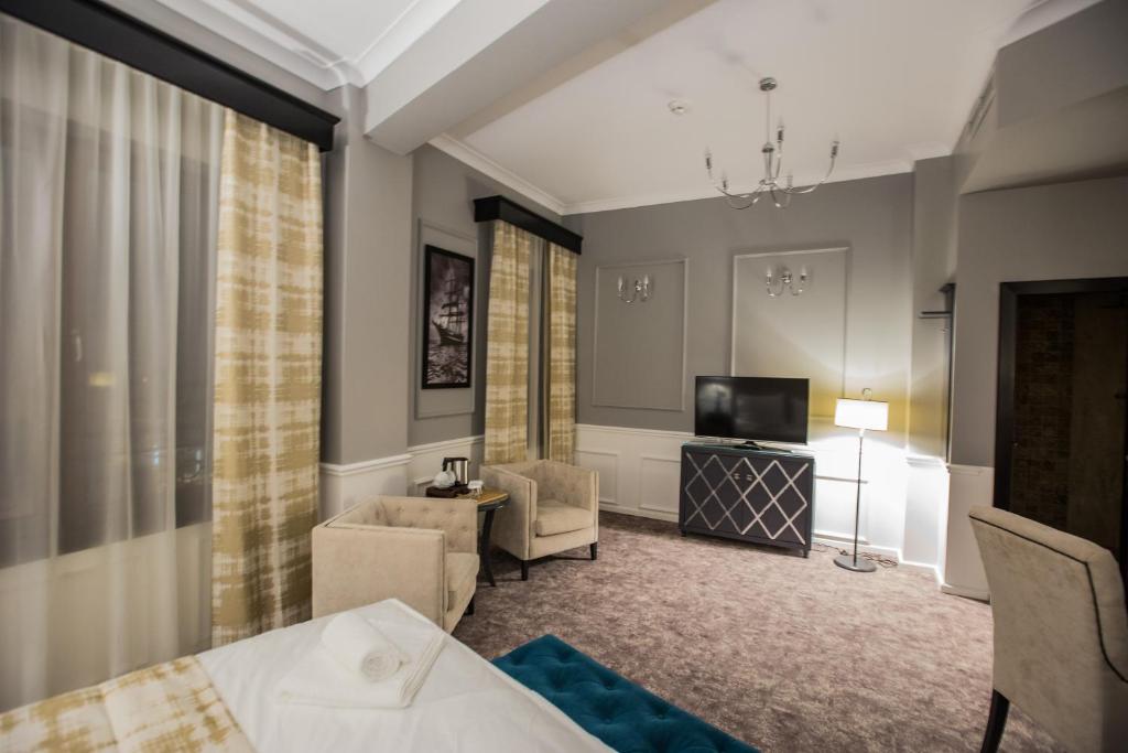 Postel nebo postele na pokoji v ubytování Peninsula Boutique Hotel
